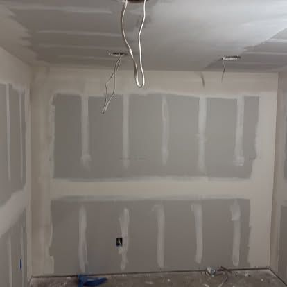 Drywall hung and taped in a remodeled room