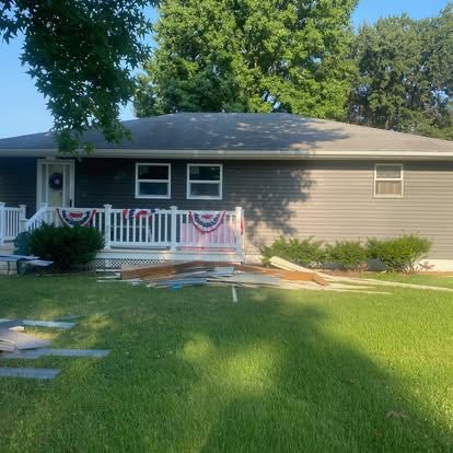A brick home exterior with a freshly worked deck and railing, the kind of residential repair we handle for St. Louis homeowners