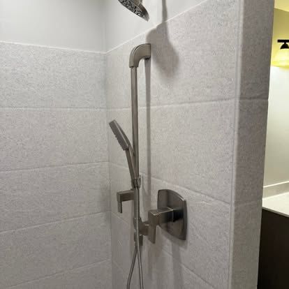 Tiled walk-in shower install with chrome fixtures