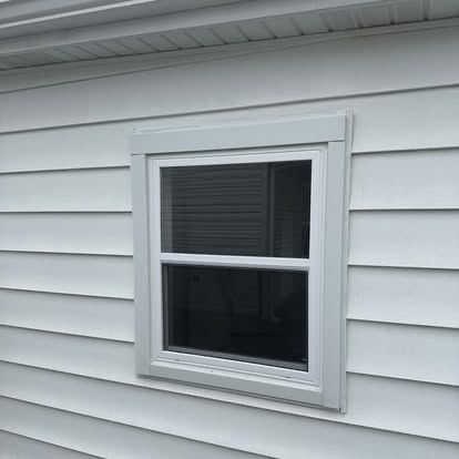 Replacement window set into vinyl siding
