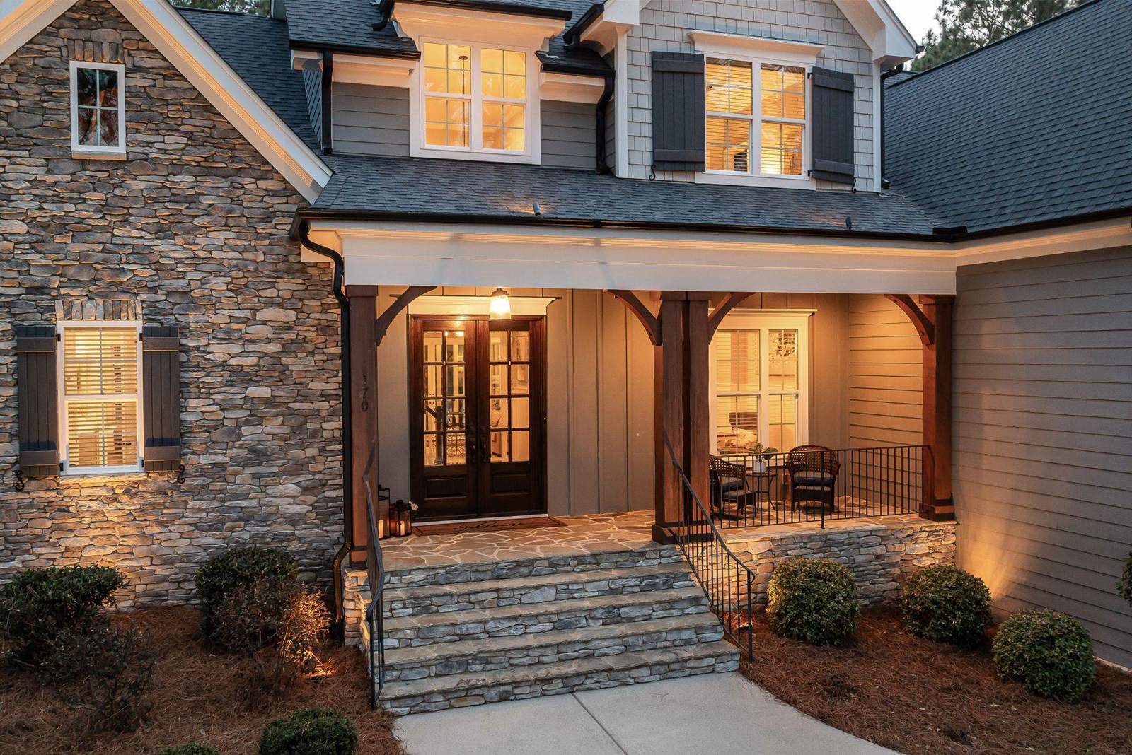 A warmly lit residential home at dusk